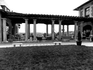 Pillar lined walkway from main house to outdoor living room