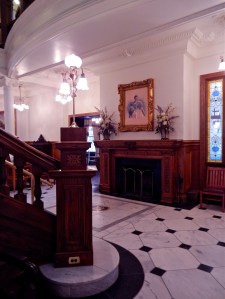 First floor fireplace at base of staircase in grand entrance. 